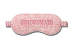 The Slip Silk Sleep Mask features a pink patterned design with "BRIDESMAID" embroidered across the front—ideal for beauty sleep before the big day.