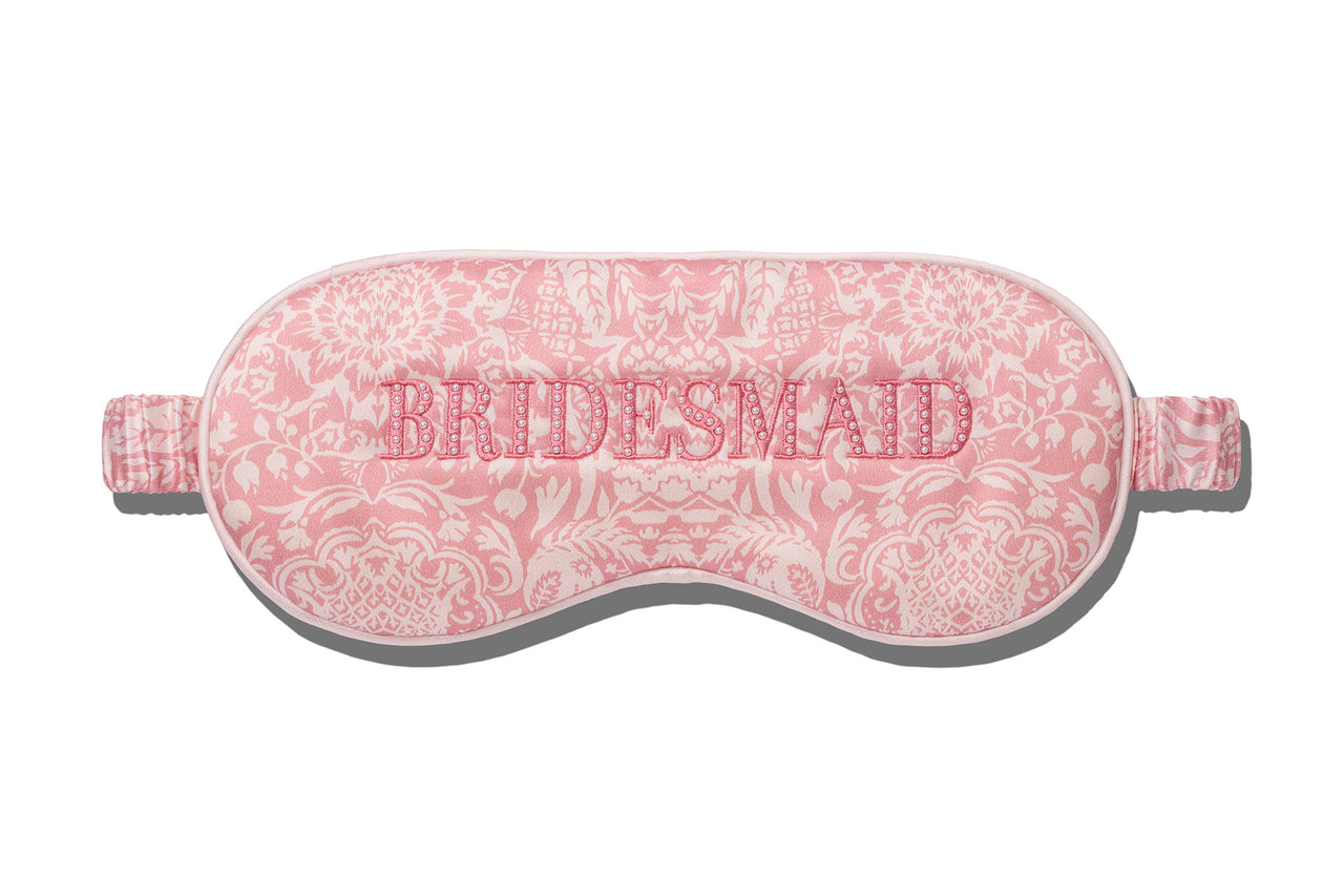 The Slip Silk Sleep Mask features a pink patterned design with "BRIDESMAID" embroidered across the front—ideal for beauty sleep before the big day.