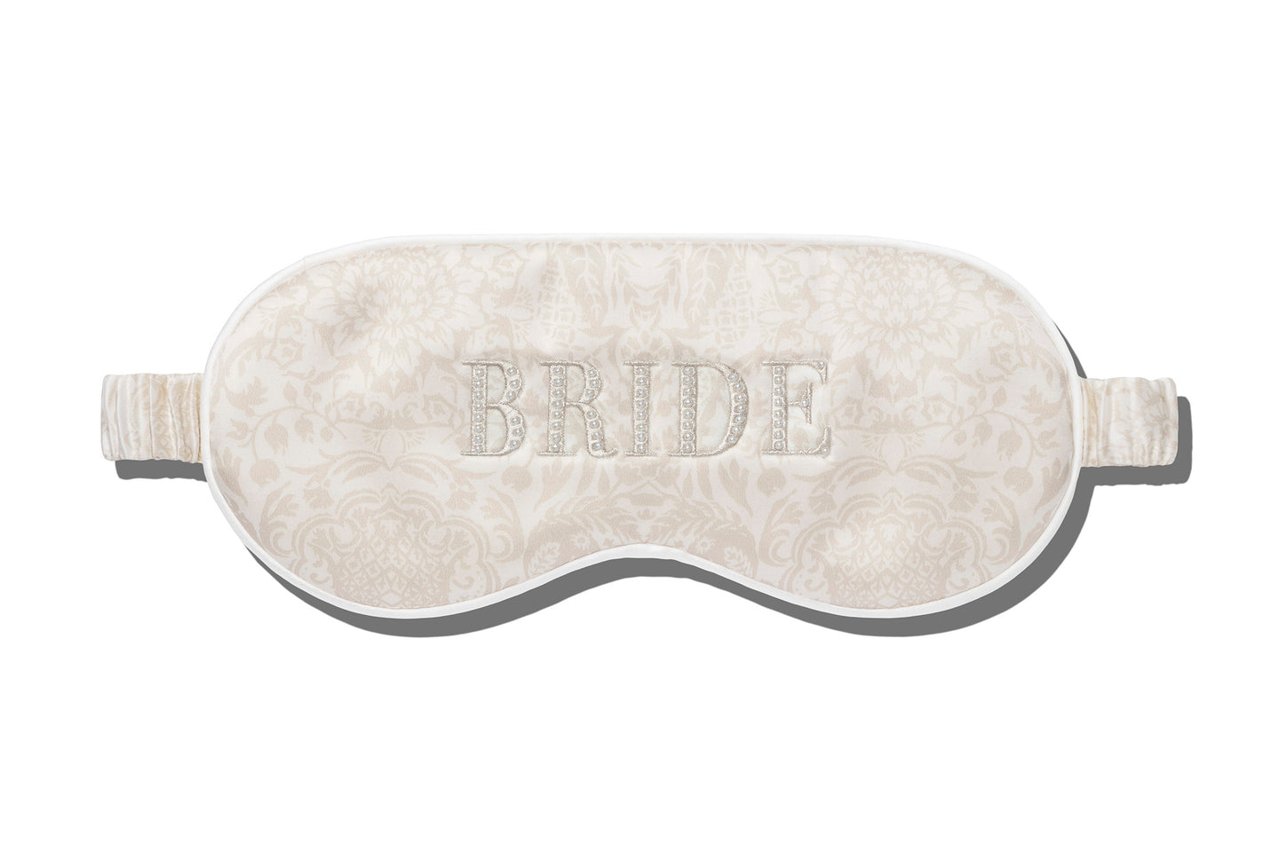 Enjoy a restful night with the Slip Silk Sleep Mask in ivory, adorned with a delicate floral pattern and "BRIDE" beautifully embroidered on the front.