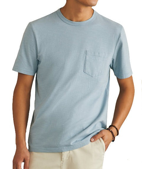 Man wearing a vintage blue Faherty Sunwashed Pocket Tee with a pocket and beige pants.