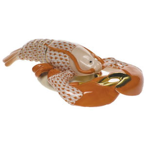 A hand-painted Herend porcelain figurine named "Lobster," featuring an orange and white patterned fish holding a golden crab claw—a charming decorative accent for any space.