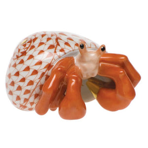 The Herend Hermit Crab is a hand-painted porcelain collectible figurine featuring a patterned white and orange shell with glossy orange claws—perfect as a decorative accent.