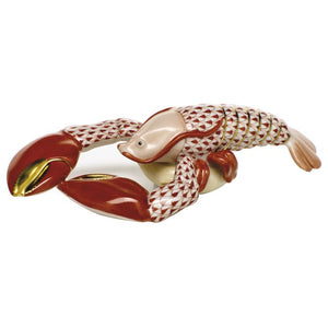 The Herend Small Lobster is a collectible porcelain figurine featuring red and white patterns, large claws, and gold accents—a timeless addition to any decorative display.