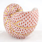 The Herend Nautilus Shell is a hand-painted porcelain figurine featuring a red fish scale pattern and gold accents on white, perfect as a collectible decorative accent.