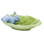 The Herend Bunny on Cabbage Leaf features a blue and white patterned rabbit figurine atop a green ceramic leaf dish, making it a timeless decorative accent.