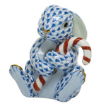 The Herend “Candy Cane Bunny” is a porcelain figurine featuring a blue and white patterned rabbit holding a red and white striped candy cane, highlighted with gold accents on its paws, nose, and mouth—an enchanting addition to your holiday décor and an ideal collectible for fans of festive or candy cane bunny figurines.