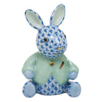 The Herend Sweater Bunny, handcrafted in Hungary, features a blue fishnet motif, light green jacket, and painted carrot on its chest.