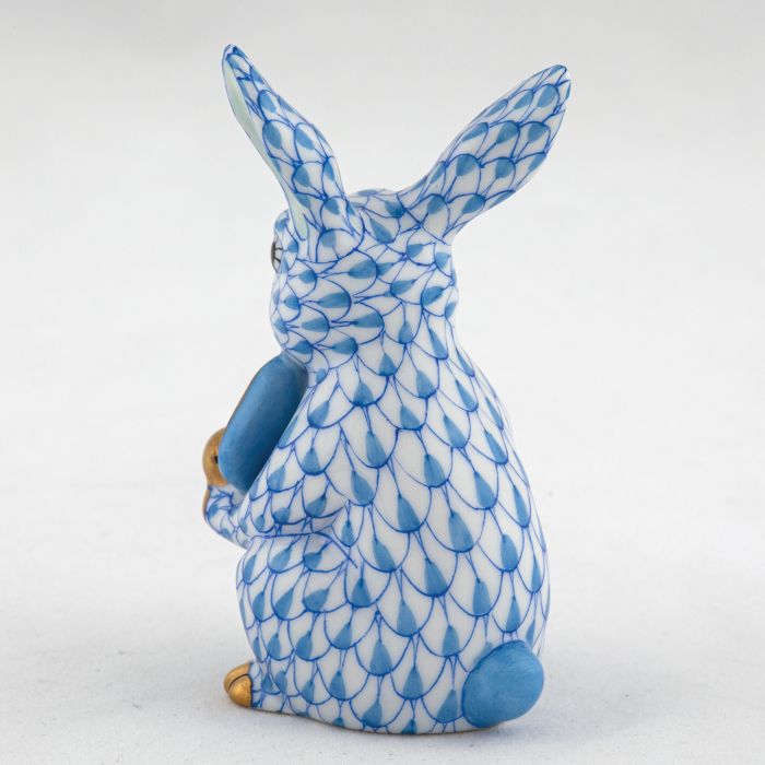 The Herend Pickleball Bunny is a blue-and-white collectible porcelain rabbit figurine with gold accents on its nose, paws, and ears, displayed from the back—a charming decorative accent with timeless appeal.