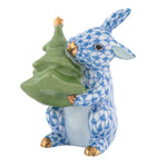 The Herend Christmas Tree Bunny is a porcelain figurine featuring a blue patterned rabbit holding a green Christmas tree, with elegant gold accents on its paws, nose, and ear tips—a charming addition to your holiday décor and the perfect collectible for fans of ceramic bunnies or unique Christmas decorations.