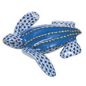 The Herend Leatherback Turtle is a hand-painted ceramic figurine featuring a blue and white patterned design with gold accents, perfect as a decorative accent.