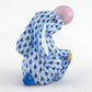 The Bubble Gum Bunny by Herend is a hand-painted ceramic figurine featuring a blue and white pattern, pink nose, and yellow toes—a delightful accent for any space.