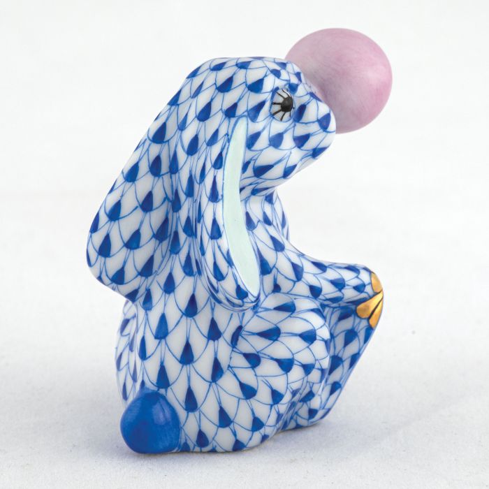The Bubble Gum Bunny by Herend is a hand-painted ceramic figurine featuring a blue and white pattern, pink nose, and yellow toes—a delightful accent for any space.