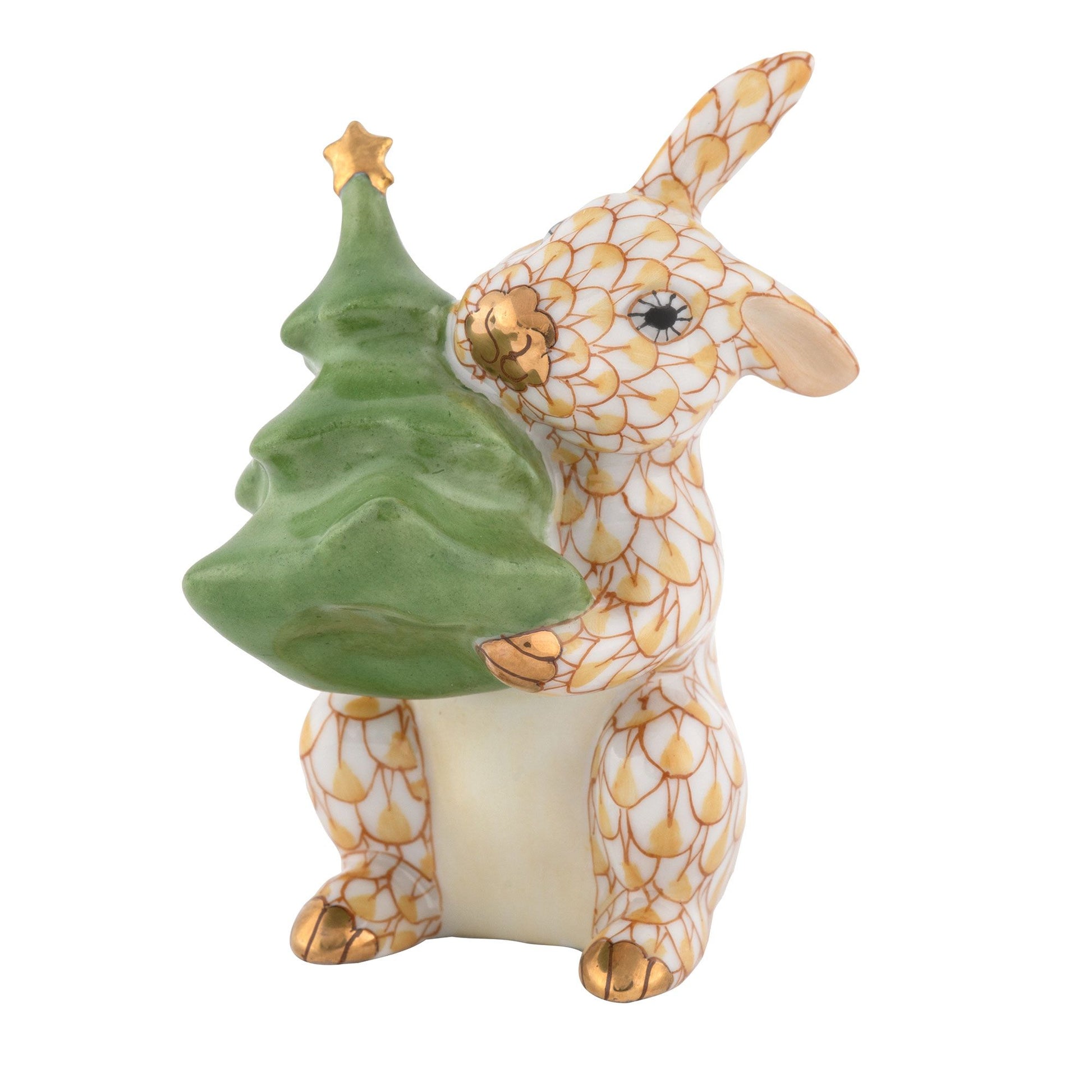 The Herend Christmas Tree Bunny is a porcelain rabbit figurine featuring a gold-and-white pattern and holding a green Christmas tree with gold accents—perfect for bringing whimsical charm to your holiday décor and pairing beautifully with other ceramic bunnies or Christmas decorations.