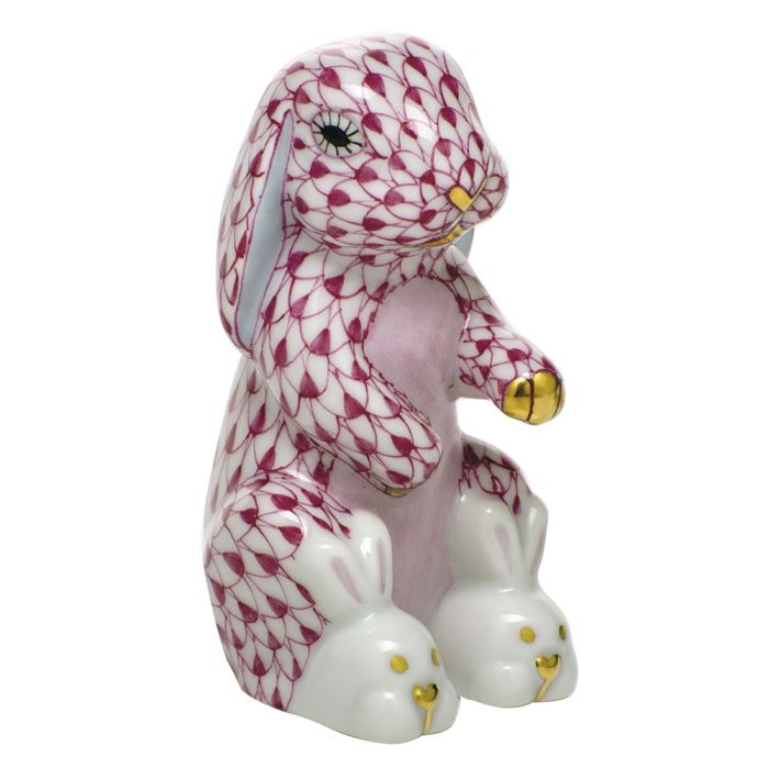 The Herend Bunny Slippers is a hand-painted porcelain collectible featuring a seated bunny with a pink and white scale pattern, gold accents, and bunny-shaped slippers—a charming decorative accent for any space.