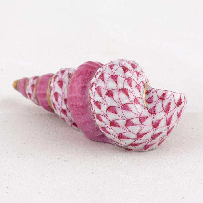 The Herend Staircase Shell Collection features a decorative ceramic seashell figurine crafted from durable porcelain, with a white base, pink scale-like pattern, and gold accents, displayed on a light background.