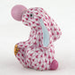 Herend’s Bubble Gum Bunny is a porcelain figurine featuring a pink and white scaled pattern, blue inner ears, a gold accent, and a pink nose—an adorable upright bunny that adds timeless charm to any decor.