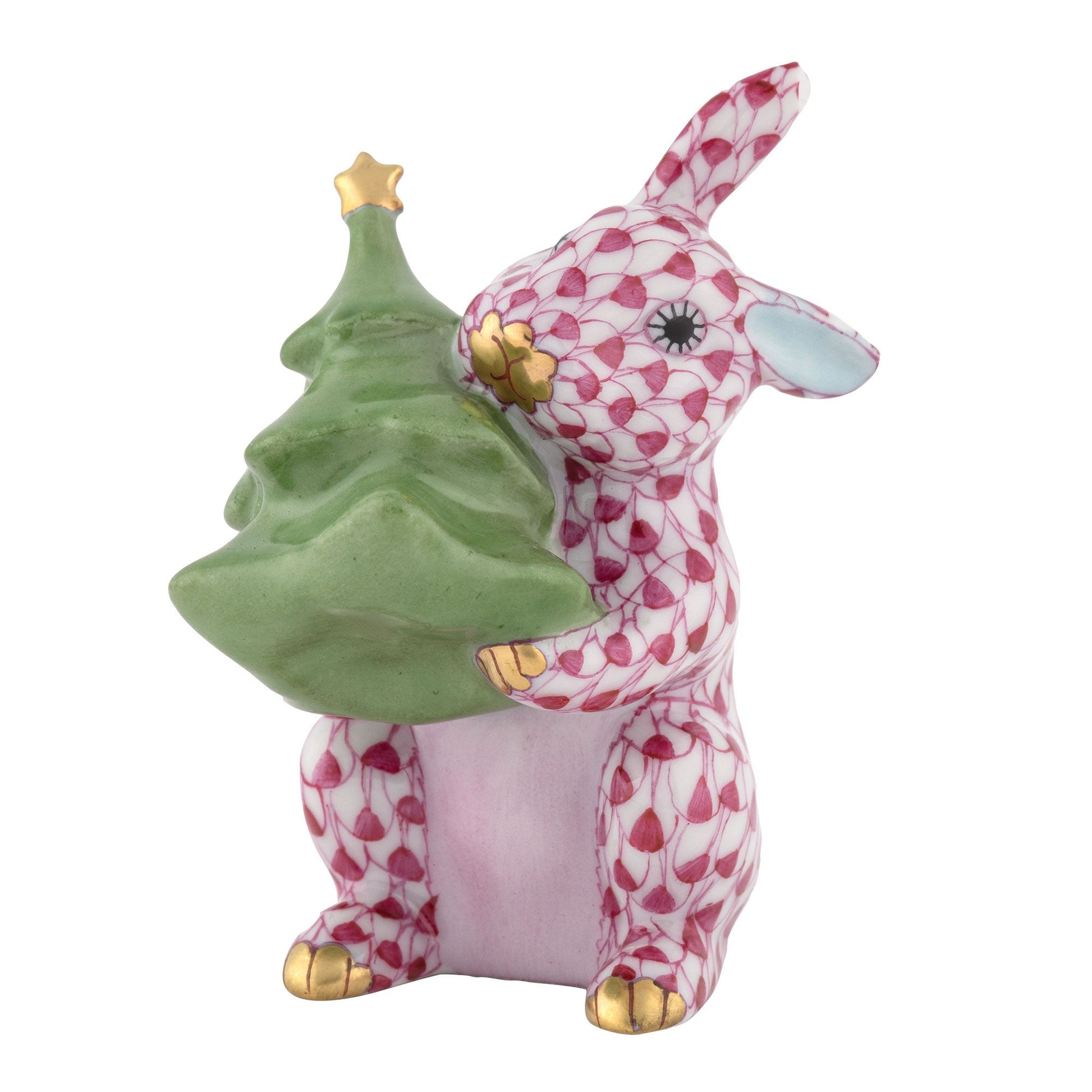 Add whimsical charm to your holiday décor with the Herend Christmas Tree Bunny—a porcelain figurine featuring a pink and white patterned rabbit holding a green Christmas tree, highlighted by gold accents on its feet, nose, and the star atop the tree. This enchanting collectible is perfect for ceramic bunny enthusiasts.