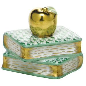 Herend's Apple on Books is a decorative ceramic accent featuring two stacked books with green and gold details, topped by a gold apple—bringing timeless elegance to any space.