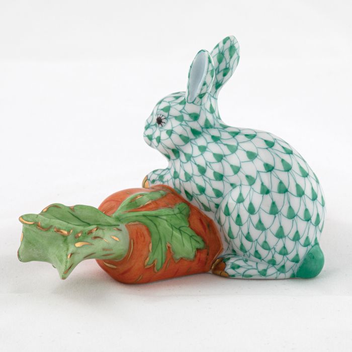 Carrot Love by Herend—a charming porcelain rabbit figurine with a green scale pattern, sitting beside an orange carrot with green leaves. A collectible piece that brings timeless elegance to any décor.