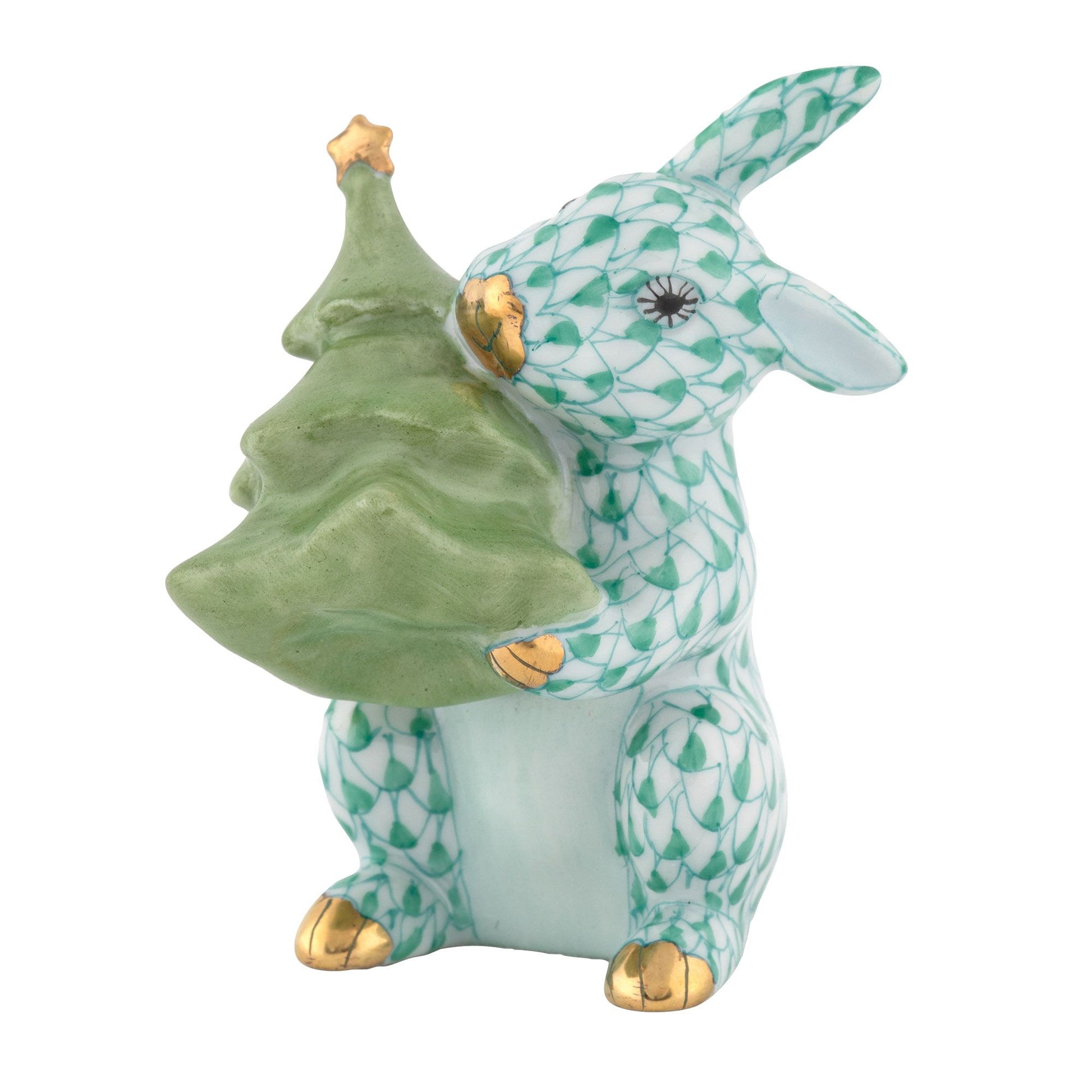Herend Christmas Tree Bunny: A porcelain rabbit figurine featuring a green fishnet pattern, gold accents, and holding a green Christmas tree—perfect as charming holiday décor or a unique addition to your collection of ceramic bunnies for festive Christmas decorations.