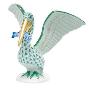 The Herend Pelican With Fish figurine features a green scale pattern, gold beak, raised wings, and a blue fish held in its beak—a collectible porcelain piece that adds timeless elegance to your decor.