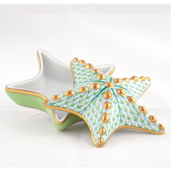 The Herend Starfish Box Collection features a porcelain box shaped like a starfish with a removable lid, hand-painted in green, gold, and white patterns, shown on a white background.