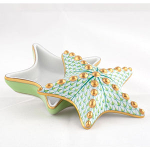 The Herend Starfish Box Collection features a porcelain box shaped like a starfish with a removable lid, hand-painted in green, gold, and white patterns, shown on a white background.