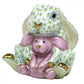 A durable Herend porcelain figurine of the Herend Bunny and Lovey seated inside a green and white patterned Easter bunny suit, adorned with hand-painted designs.