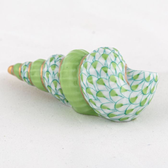 The Herend Staircase Shell Collection features a decorative porcelain seashell with green and white scale-like patterns, gold accents, and exquisite hand-painted designs, displayed on a plain white surface.