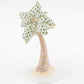 Herend Palm Tree: Porcelain figurine with hand-painted green patterned leaves and gold accents, set on a white circular base. Durable and exquisitely crafted for elegant display.