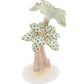 The Herend Palm Tree is a hand-painted porcelain figurine featuring patterned green leaves, gold accents, and a light brown trunk on a white base.