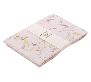 The Gooselings Dreaming of Paradise Swaddle is a soft, 100% cotton light pink floral blanket, wrapped with a cream band—perfect for gently comforting your baby.