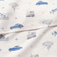 Gooselings' Transit Treasures Swaddle features blue cars, trains, planes, balloons, ships, and stars on white 100% cotton—perfectly cozy for your baby blanket or swaddle needs.