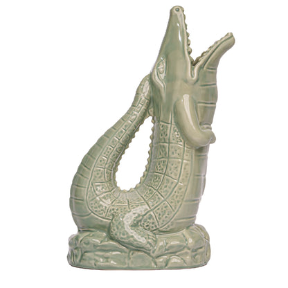 The Original Gluggle Jug Croggle Jug is a ceramic, crocodile-shaped jug with an open mouth and glossy pale green finish—ideal for collectors of quirky jugs.