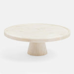 The Blue Pheasant Cake Stand by Blue Pheasant features a round, solid marble top and thick tapered base, elegantly displayed against a white background.