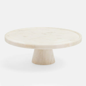 The Blue Pheasant Cake Stand by Blue Pheasant features a round, solid marble top and thick tapered base, elegantly displayed against a white background.
