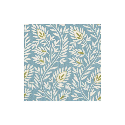 The Samsara Collection by Caspari features a square tile with a blue background and a repeating pattern of white leafy branches and green florals, inspired by eco-friendly napkins and natural designs.