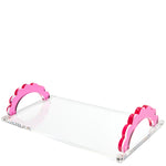 The Scallop Handle Photo Tray Collection by Tara Wilson Designs features a clear acrylic tray with pink scalloped handles, shown against a white background.