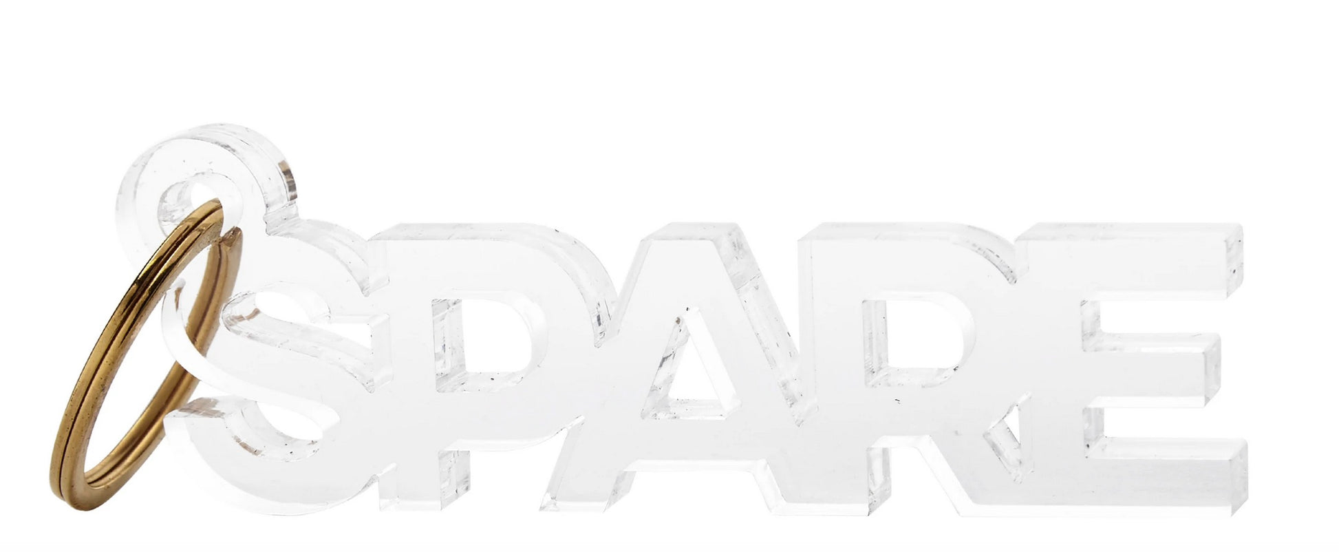 The Acrylic Key Chain Collection by Tara Wilson Designs features a transparent key chain that spells "SPARE" in block letters and includes a stylish gold metal ring.