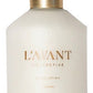 A clear bottle of L’Avant Collective Hand Lotion from the Fresh Linen Scent Collection, with a black pump and gold collar, features gold text—perfect for pairing with their luxurious hand soaps.