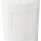 A white candle in a glass container with minimalist design, labeled L’Avant Collective, complements the Fresh Linen Scent Collection of luxurious hand soaps and laundry detergent.