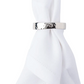 A white cloth napkin is folded and held upright by a Juliska Puro Napkin Ring, crafted from aluminum with nickel plating.