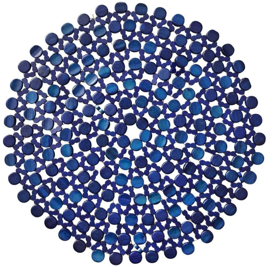 The Kim Seybert Bamboo Round Placemat features interlinked dark and light blue discs in a geometric design, perfect for formal tablescapes or bringing charm to your outdoor table décor.