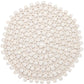 A dense arrangement of small, white tablets on a white background resembles the Bamboo Round Placemat by Kim Seybert, adding a touch of elegance to any formal tablescape.