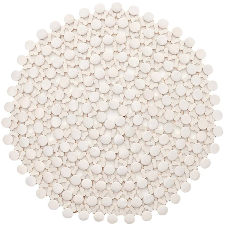 A dense arrangement of small, white tablets on a white background resembles the Bamboo Round Placemat by Kim Seybert, adding a touch of elegance to any formal tablescape.