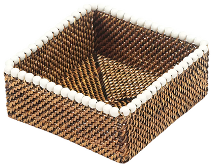 The Calaisio Cocktail Napkin Holder Collection features a square woven design with a checkered brown pattern and white beaded rim, adding eco-chic style to any setting.