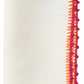 The Kim Seybert Knotted Edge Napkin Set features white 100% linen napkins, folded rectangularly, with orange and pink decorative edge stitching.