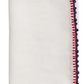 The Knotted Edge Napkin Set by Kim Seybert features white 100% linen napkins with hand-crocheted red and blue edging.