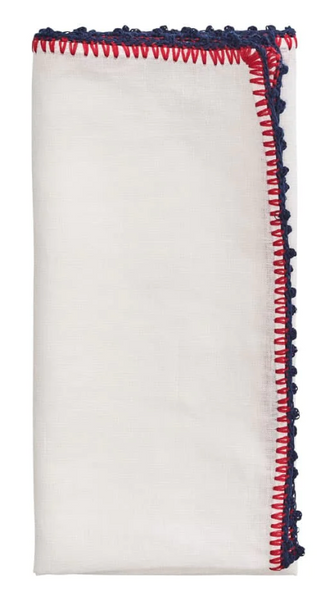 White linen fabric folded with Kim Seybert Knotted Edge Napkin, Set of 4 fringe on the edges, isolated on a white background.