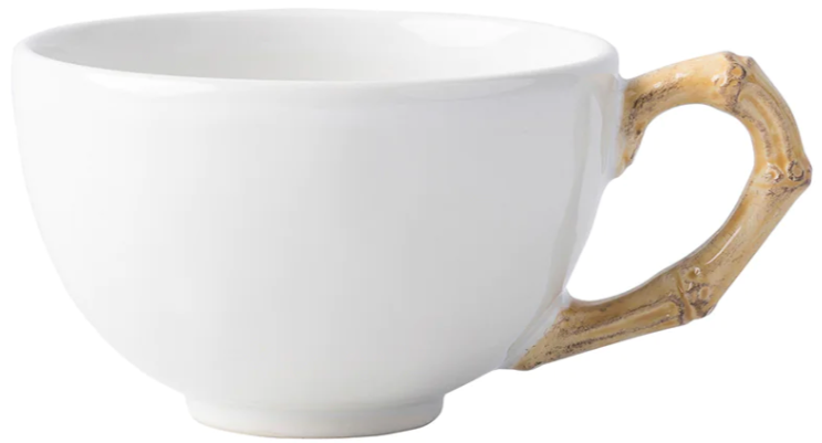 A white ceramic cup from Juliska’s Classic Bamboo Dinnerware Collection has a bamboo-shaped handle, adding casual elegance and global style to your table.